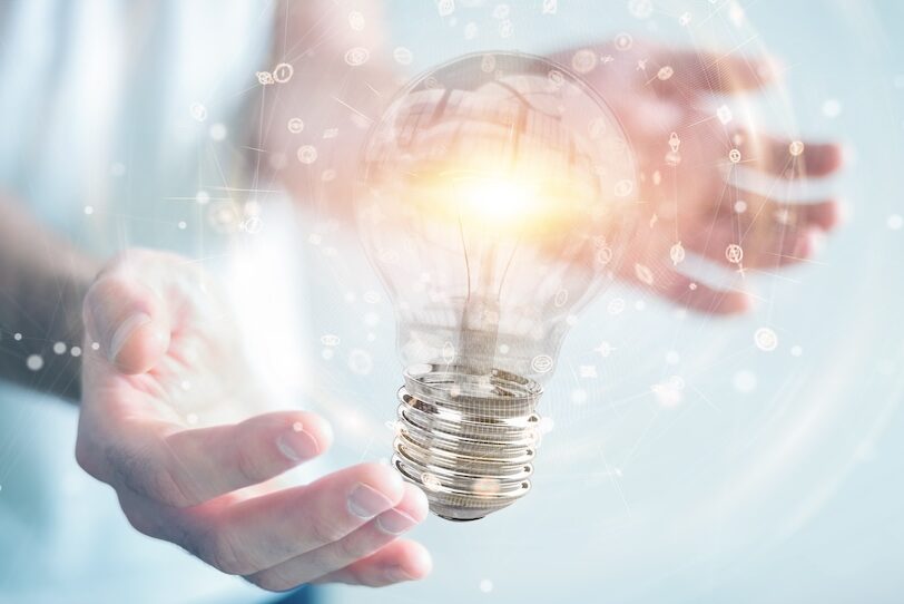 Businessman connecting modern lightbulbs with connections 3D rendering